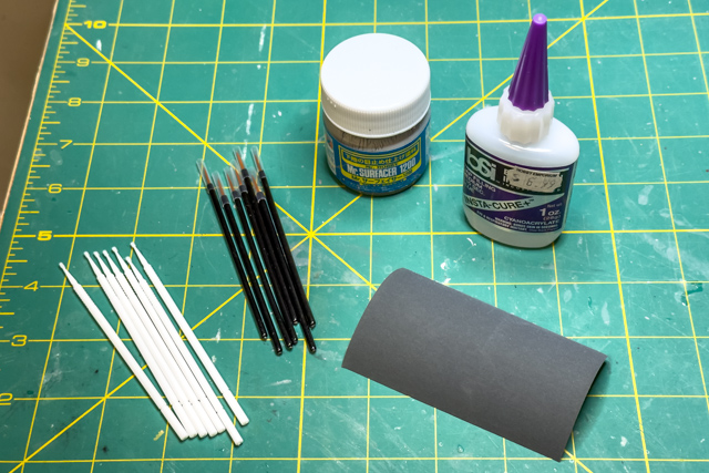 Micro-applicators, disposable make-up brushes, Mr.Surfacer, CA glue, and wet-sanding paper.